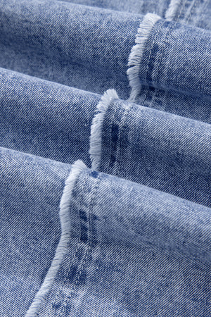 Acid wash denim shirtdress in medium blue with raw hem detail.