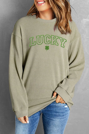 Light green textured ribbed crewneck sweatshirt with "Lucky" graphic and clover detail.