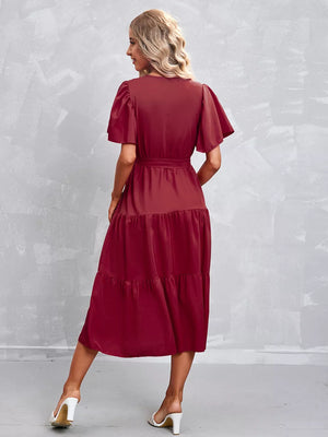 Belted midi gown in Scarlet with flutter sleeves and tiered skirt.
