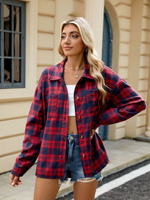 Red and navy plaid collared long sleeve shirt with button front and chest pockets.