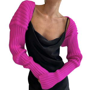 Hot Pink ribbed knit shrug with extended sleeves, styled over a black slip dress.