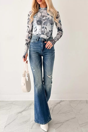 Sheer floral high neck long sleeve shirt with a grey and white floral pattern.