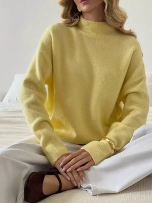 Relaxed mock neck knit sweater in pastel yellow, acrylic blend, with long sleeves.