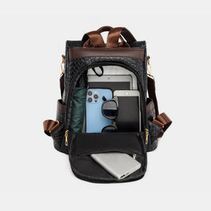 Black woven faux leather convertible backpack with brown straps, showing interior organization.