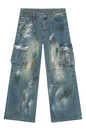 Artisan denim cargo pants in medium wash with paint splatters and wide legs.