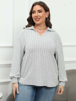 Relaxed ribbed polo top in grey with a collared neckline and long sleeves.
