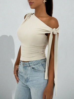 Apricot asymmetrical tie detail cropped blouse with one shoulder and tie sleeves.