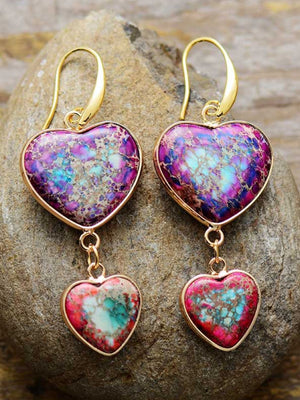 Heart stone cascade earrings in electric purple with gold hooks and dangling smaller hearts.