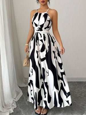 Maxi dress with halter neck, abstract print, and tie waist in black and white.