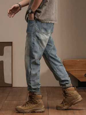 Relaxed fit vintage wash denim jeans with paneling detail and rolled cuffs.