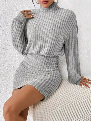 Light gray ribbed turtleneck mini dress with ruched detail and long sleeves.