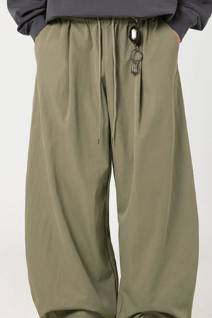 Sage balloon-fit drawstring trousers with a relaxed casual style.