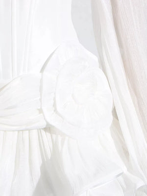 White ruffle mini dress with balloon sleeves, featuring a ruched bodice and delicate fabric detail.