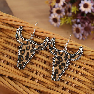 Leopard print bull head drop earrings with silver beaded trim.