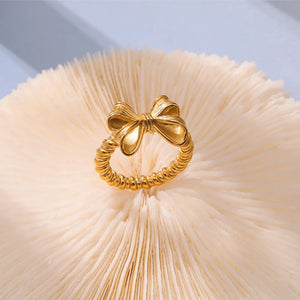 Gold textured bow knot ring with twisted band detail