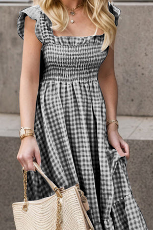 Smocked gingham maxi dress with flutter sleeves and square neckline.