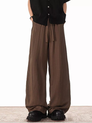 Brown relaxed fit drawstring sweatpants with pockets and a wide leg.