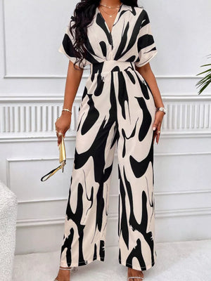 Black and white abstract print wide-leg romper with V-neck and short sleeves.