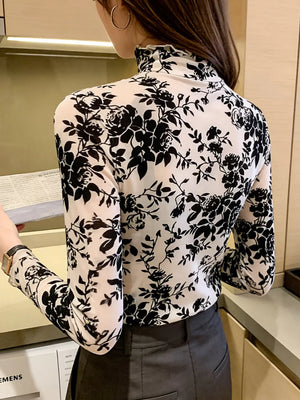 Sheer floral maternity t-shirt with ruffles and mock neck.
