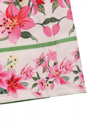 Charming floral midi dress with pink lilies and green accents.