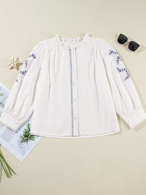 White embroidered blouse with ruffled neckline and scalloped trim cuffs
