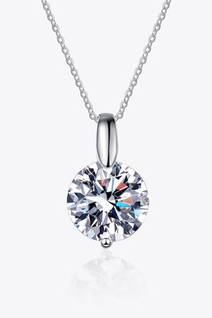 Silver solitaire moissanite pendant necklace with a round cut stone.