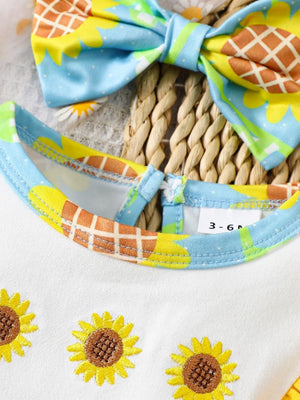 Baby cotton one-piece with sunflower embroidery and a matching bow headband.