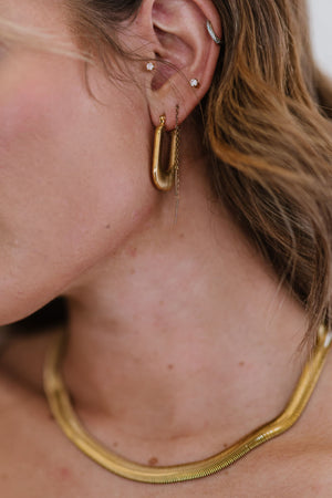 Gold textured rectangular hoop earrings with a chain drop detail.