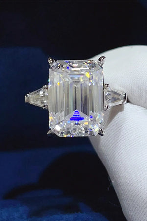 Silver ring with emerald cut moissanite and trillion side stones