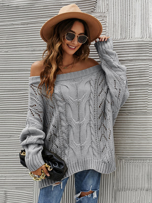 Gray cable knit off-shoulder sweater with open knit details and slouchy fit.