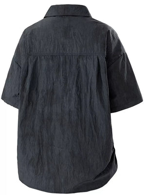 Black relaxed fit camp collar men's shirt with short sleeves and a textured finish.