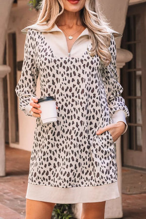 Leopard print zip-up collar mini dress with pockets and long sleeves.