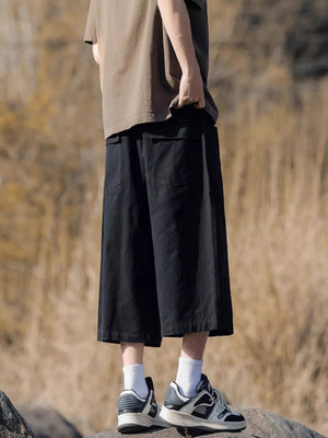 Black relaxed fit cropped sweatpants with drawstring and pockets.