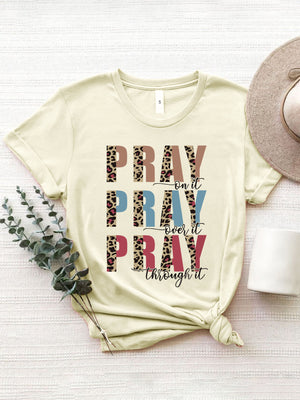 Cream graphic t-shirt with "PRAY on it PRAY over it PRAY through it" text and leopard print details.