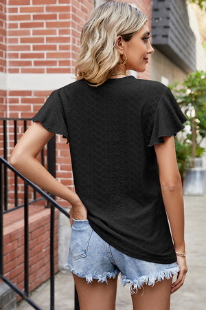 Black eyelet flutter sleeve blouse with textured pattern.
