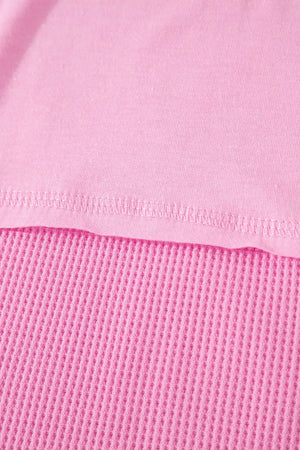 Pink waffled seam pocketed t-shirt detail showing textured waffle knit fabric.