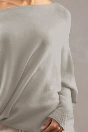 Light Gray off-shoulder knit sweater with textured cuffs and draped neckline.