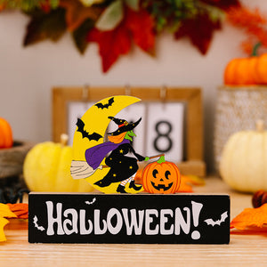 Halloween wooden display with witch on broom, moon, pumpkin, and text.