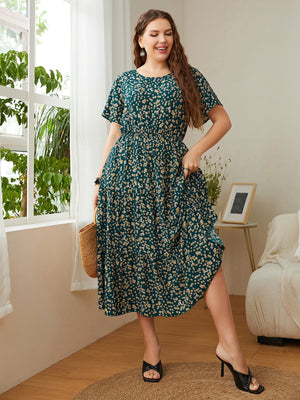 Emerald floral midi dress in deep teal, 100% polyester, with short sleeves and tiered skirt.