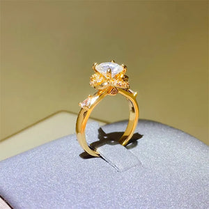 Gold statement ring with floral halo moissanite and accent stones.