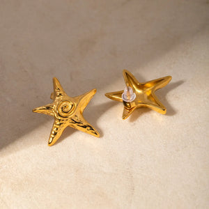 Gold starfish stud earrings with textured detail and spiral center.