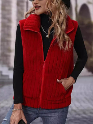 Red plush corduroy zip-up gilet with vertical ribbing and pocket details.