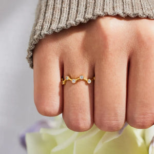 Gold wave ring with scattered clear zirconia stones, celestial design