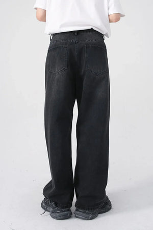 Black denim jeans with a relaxed fit and two back pockets.