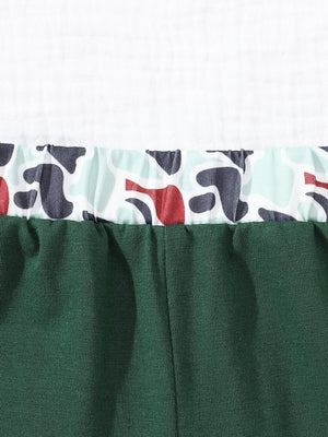 Baby polo and shorts set in dark green with camouflage trim.