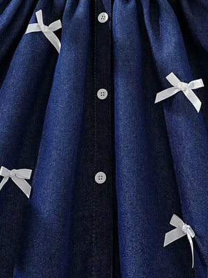 Dark blue denim baby dress with white bowknot details and buttons.
