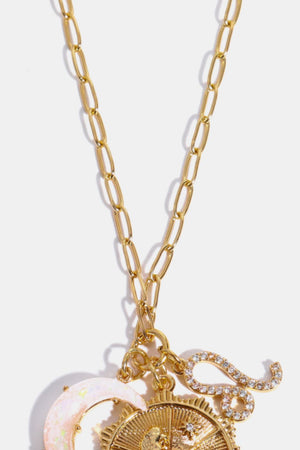 Gold celestial pendant necklace with moon, sun, and zodiac charms.