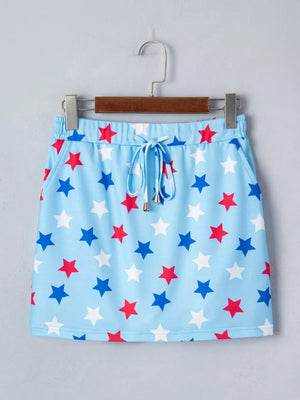 Light blue drawstring skort with red and blue star pattern and pockets.