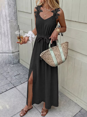 Black lace-trimmed maxi dress with V-neck, tie waist, and high slit.