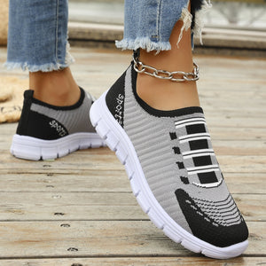 Mesh slip-on sneakers in grey and black with white soles and "Sports" detail.